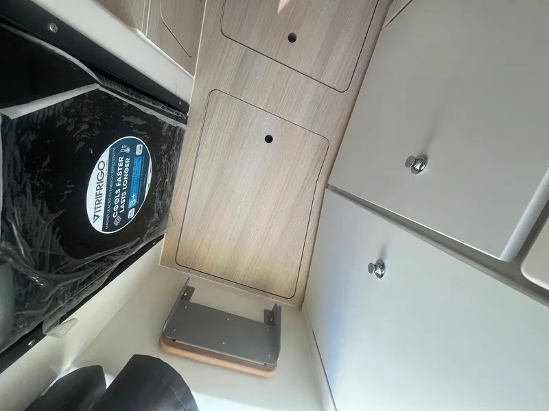 Slide: The Image of Interior view of 2025 Bayliner Trophy T25 Pilothouse, featuring storage compartments and modern design. - 20