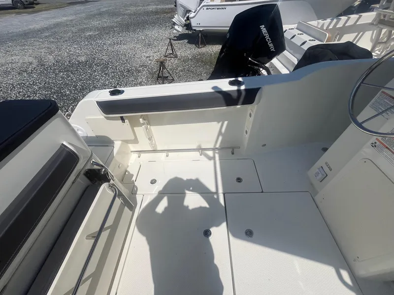 Slide: The Image of 2025 Bayliner Trophy T25 Pilothouse boat interior with seating and storage. - 34