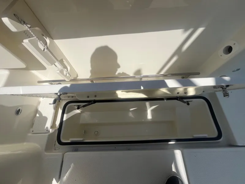 Slide: The Image of 2025 Bayliner Trophy T25 Pilothouse interior storage compartment with shadow. - 35
