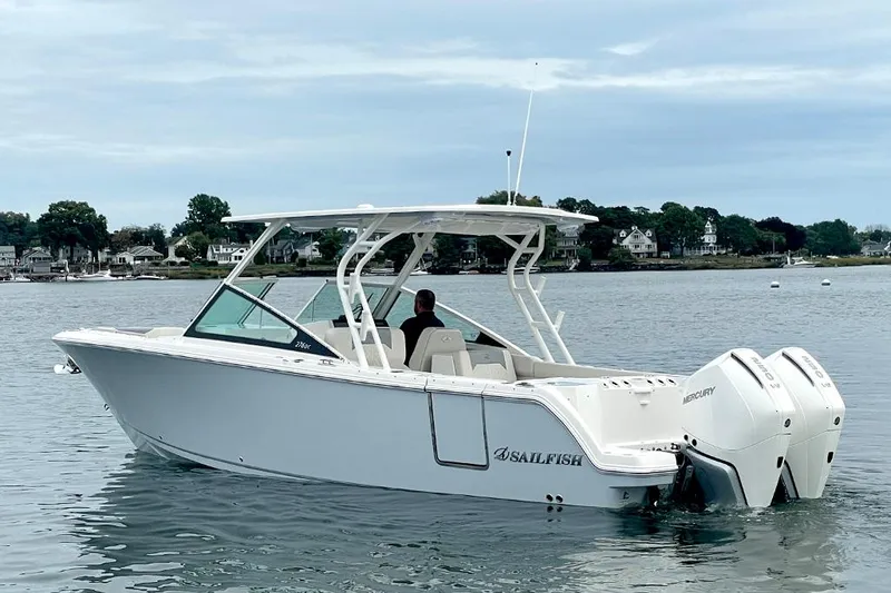 The Image of 2025 Sailfish 276 DC boat on calm water with twin outboard engines. - 1