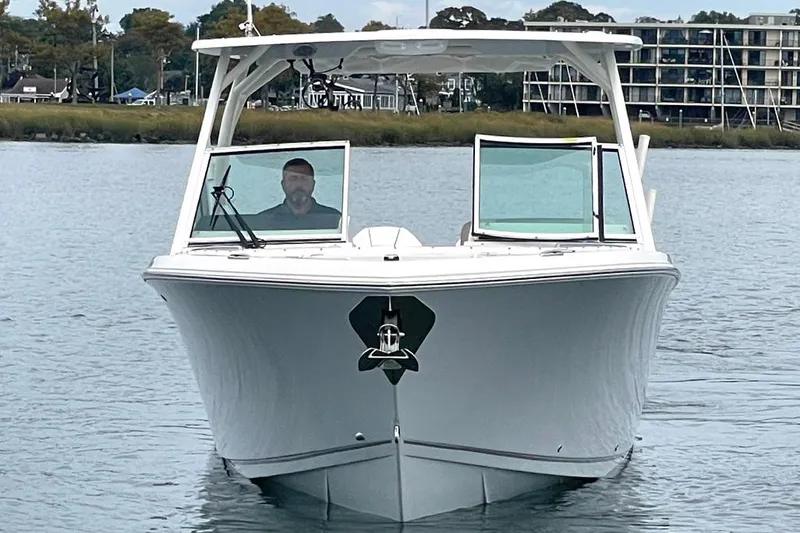 Slide: The Image of 2025 Sailfish 276 DC boat on water, front view with open windows. - 5
