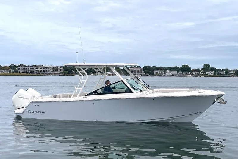 Slide: The Image of 2025 Sailfish 276 DC boat on calm water, side view. - 7