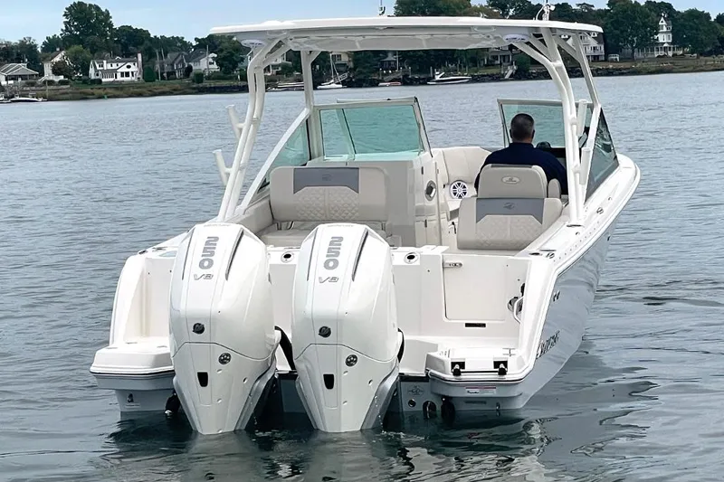 Slide: The Image of 2025 Sailfish 276 DC boat with dual engines on calm water. - 8