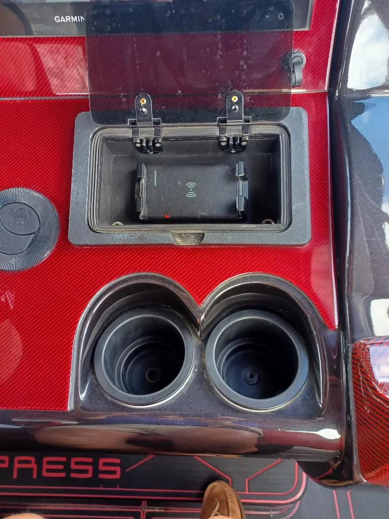 Slide: The Image of Midnight Express 43' Solstice 2022 boat console with cup holders and storage compartment. - 12