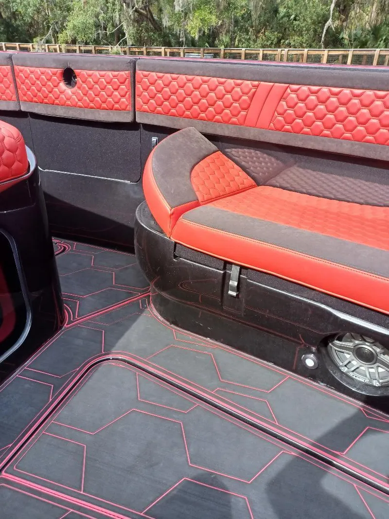 Slide: The Image of 2022 Midnight Express 43' Solstice boat interior with red and black seating and hexagonal patterns. - 17