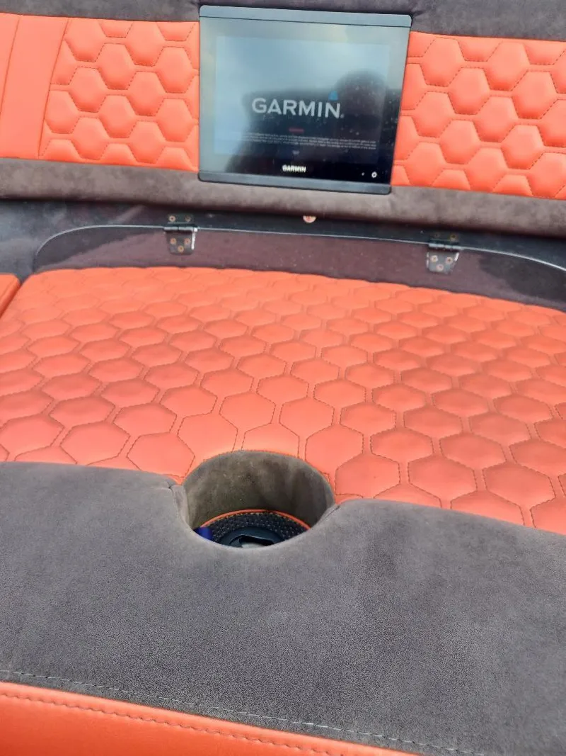 Slide: The Image of Luxurious interior of 2022 Midnight Express 43' Solstice with Garmin display and orange seating. - 18