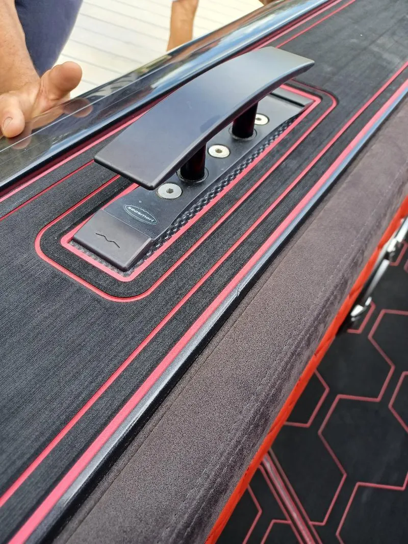 Slide: The Image of Close-up of 2022 Midnight Express 43' Solstice boat deck with sleek design and red accents. - 19