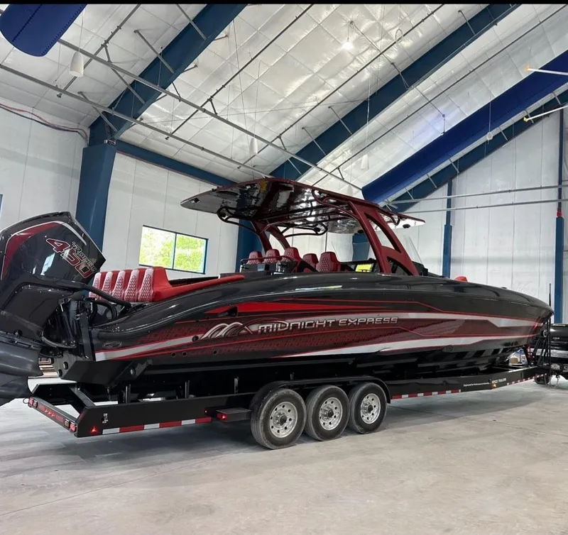 Slide: The Image of 2022 Midnight Express 43' Solstice boat on trailer in indoor facility. - 2