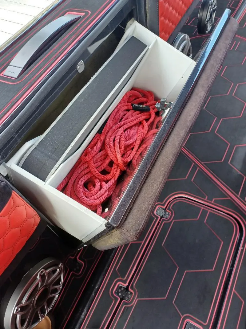 Slide: The Image of Storage compartment with red rope on a 2022 Midnight Express 43' Solstice boat. - 20