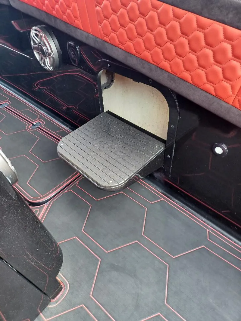 Slide: The Image of 2022 Midnight Express 43' Solstice interior with red hexagonal upholstery and retractable step. - 21