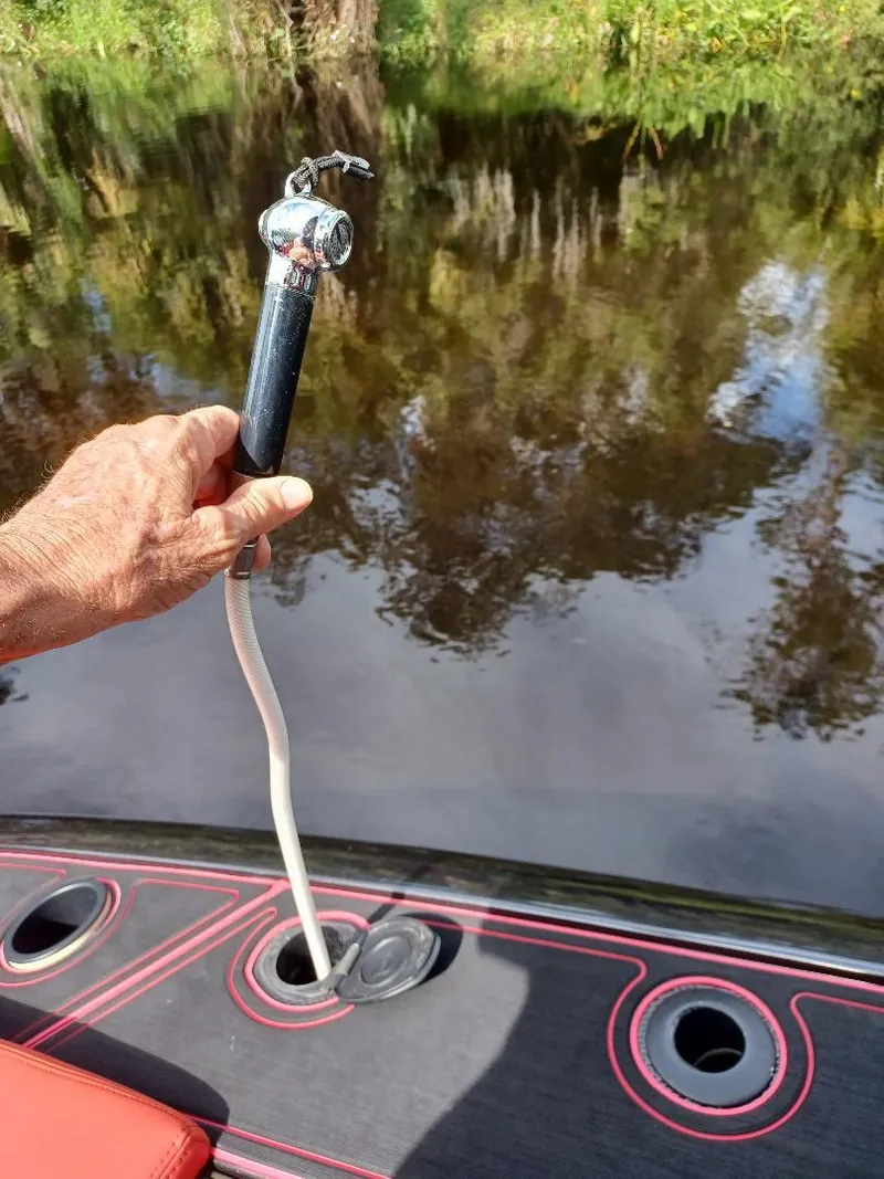 Slide: The Image of Hand holding a boat showerhead on a 2022 Midnight Express 43' Solstice. - 22