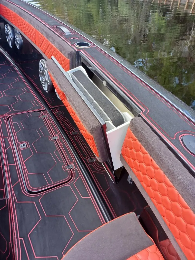 Slide: The Image of 2022 Midnight Express 43' Solstice boat interior with orange and black seating. - 23