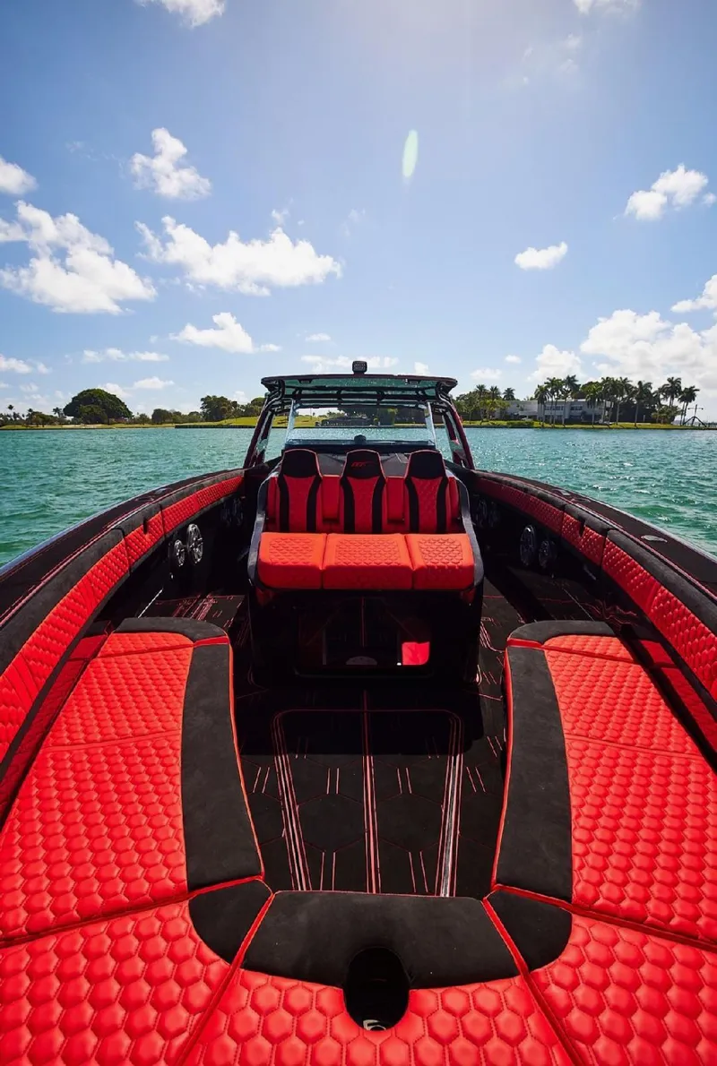 Slide: The Image of Luxurious 2022 Midnight Express 43' Solstice boat with vibrant red interior on open water. - 25