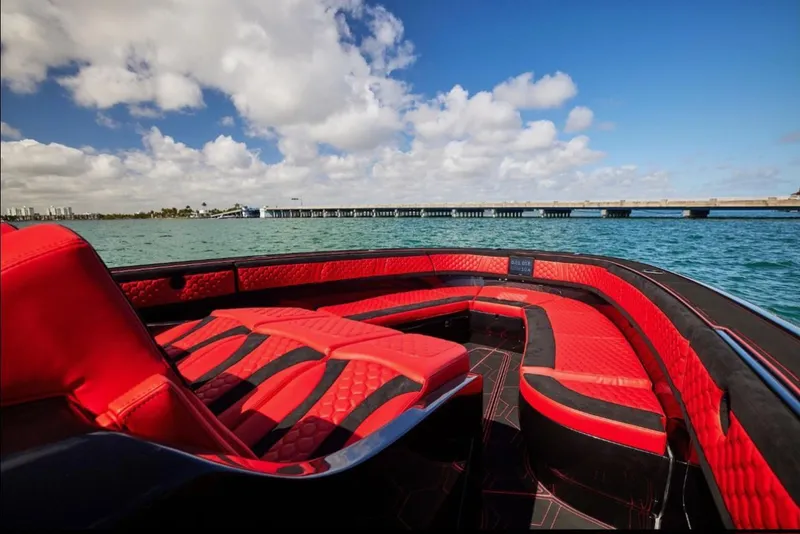 Slide: The Image of Luxurious 2022 Midnight Express 43' Solstice boat with red seating, ocean view, and blue sky. - 26