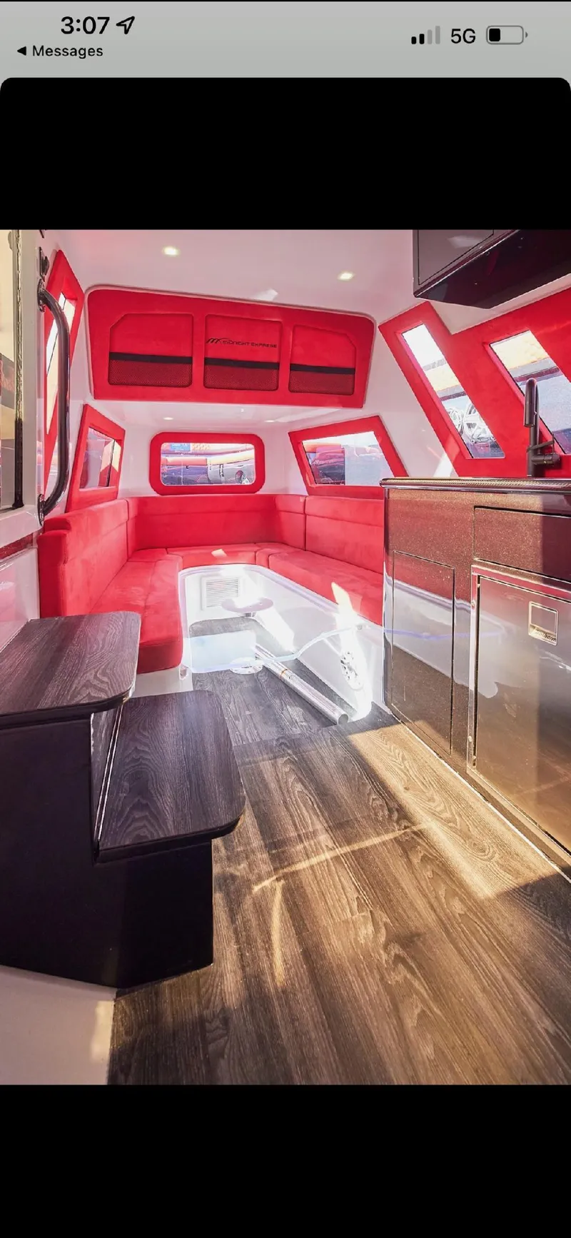 Slide: The Image of Interior of 2022 Midnight Express 43' Solstice boat with red seating and modern design. - 29