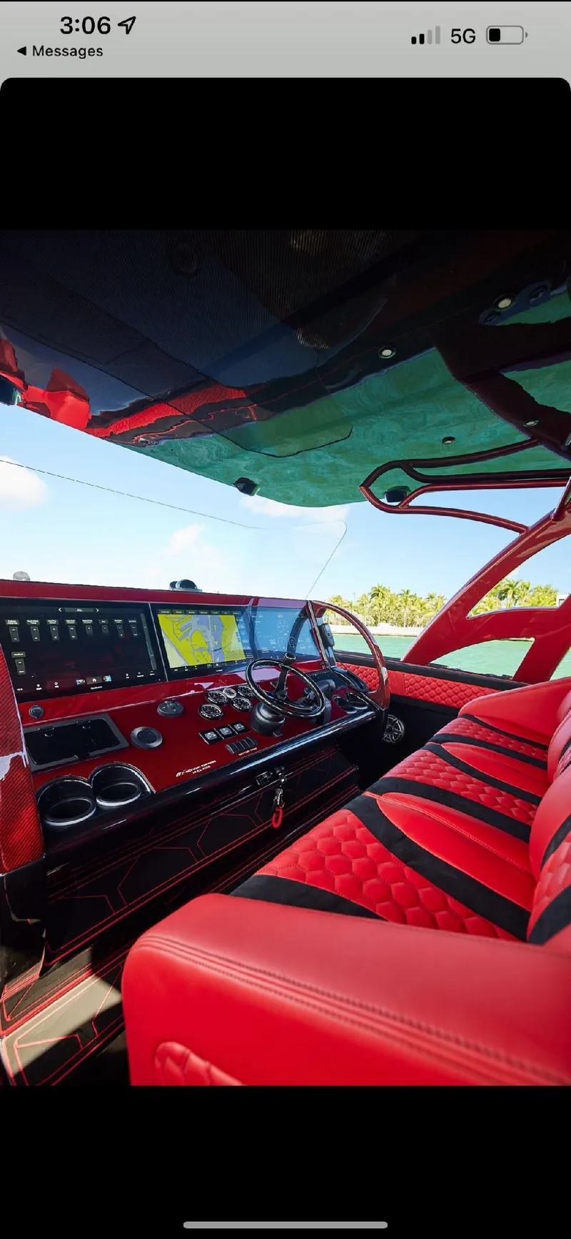 Slide: The Image of 2022 Midnight Express 43' Solstice boat interior with red seating and advanced dashboard. - 31