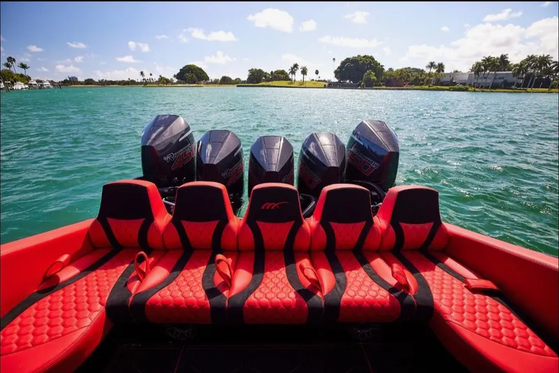 Slide: The Image of Red and black seating on 2022 Midnight Express 43' Solstice boat with five engines. - 32