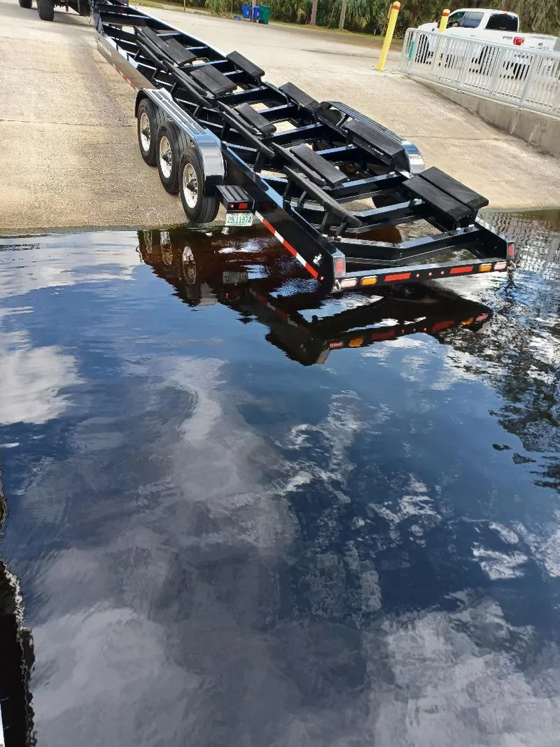Slide: The Image of Boat trailer for 2022 Midnight Express 43' Solstice near water. - 36