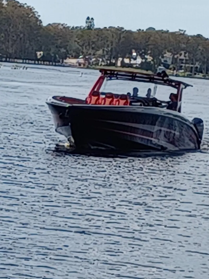 Slide: The Image of 2022 Midnight Express 43' Solstice boat cruising on a calm lake. - 4