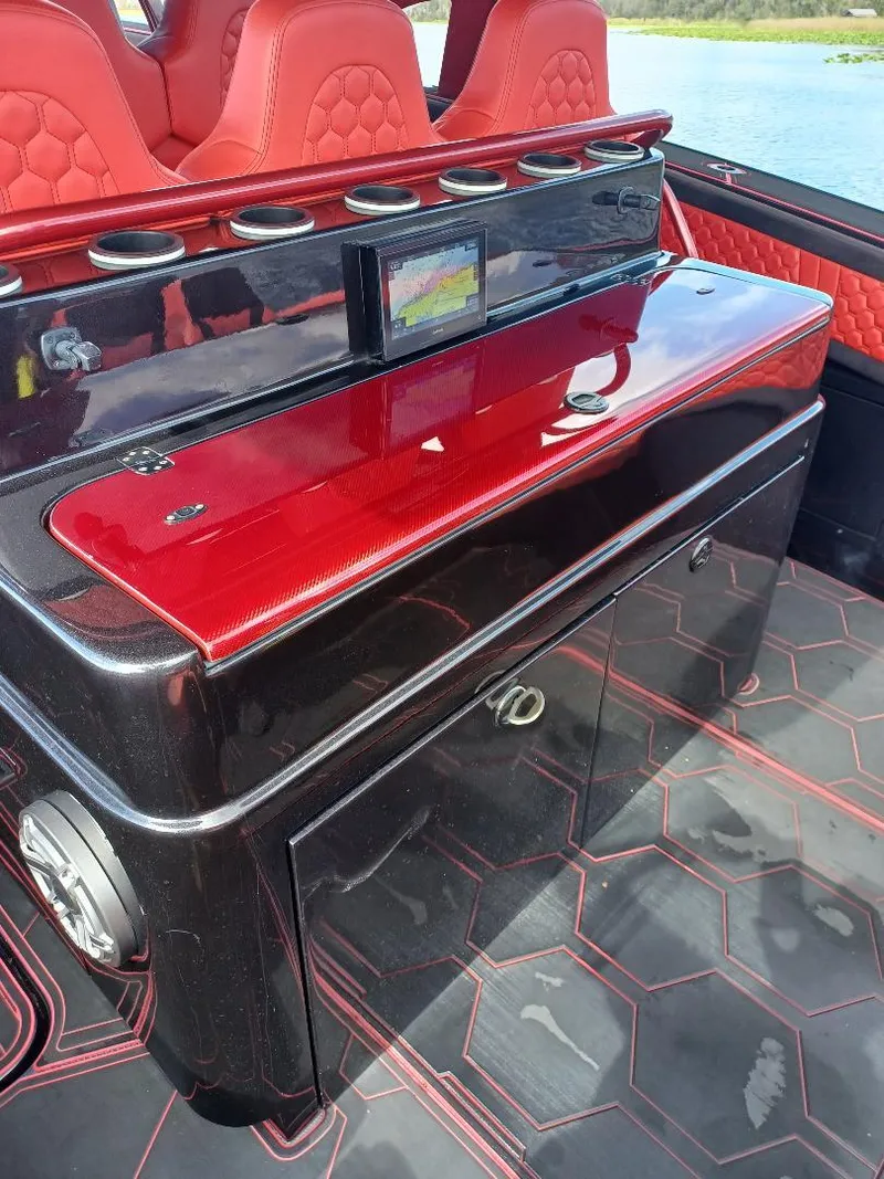 Slide: The Image of Luxury interior of 2022 Midnight Express 43' Solstice boat with red and black seating. - 6