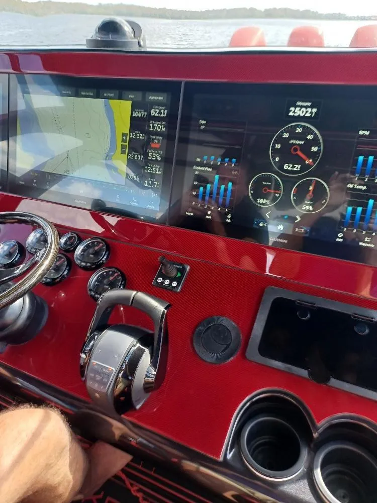 Slide: The Image of Dashboard of 2022 Midnight Express 43' Solstice boat with navigation and control displays. - 9