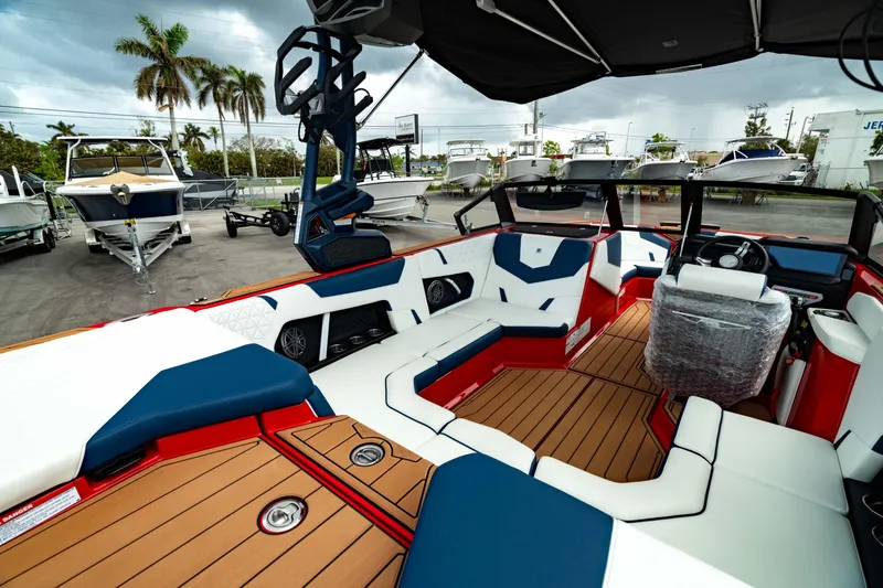 Slide: The Image of 2025 Nautique Super Air Nautique GS20 boat interior with modern seating and sleek design. - 16