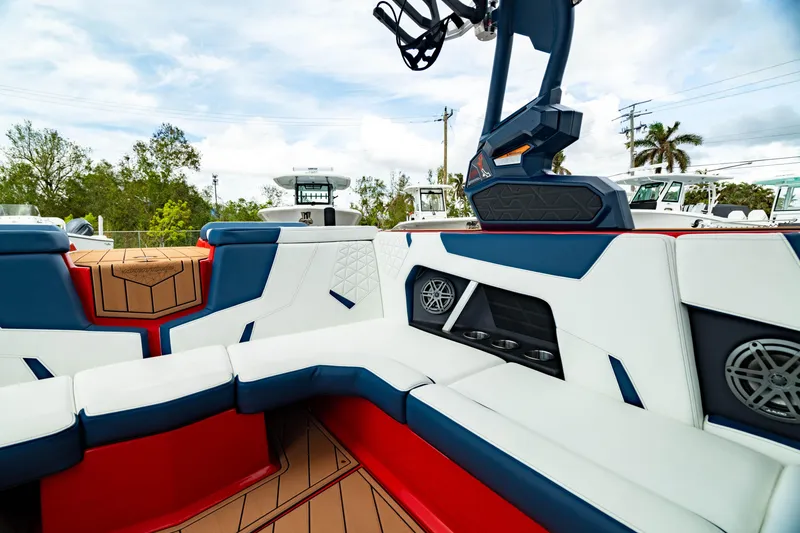 Slide: The Image of 2025 Nautique Super Air Nautique GS20 interior with red, white, and blue seating. - 17
