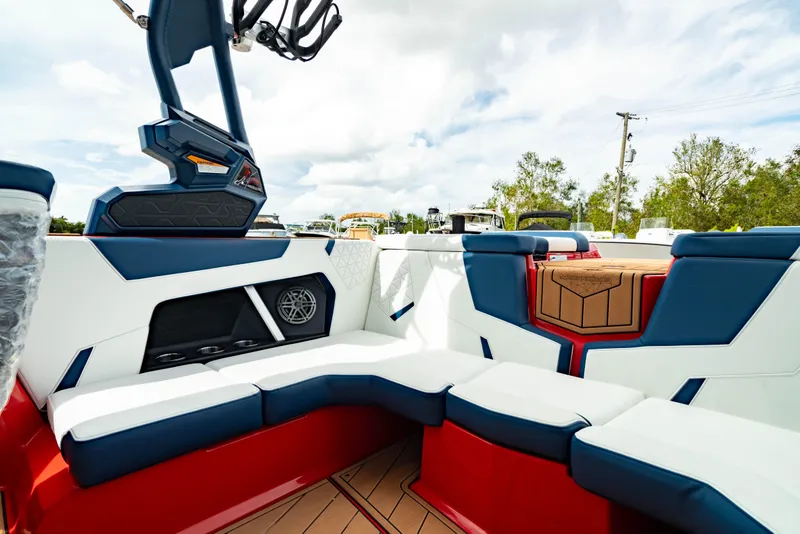 Slide: The Image of 2025 Nautique Super Air Nautique GS20 interior with red, white, and blue seating. - 18
