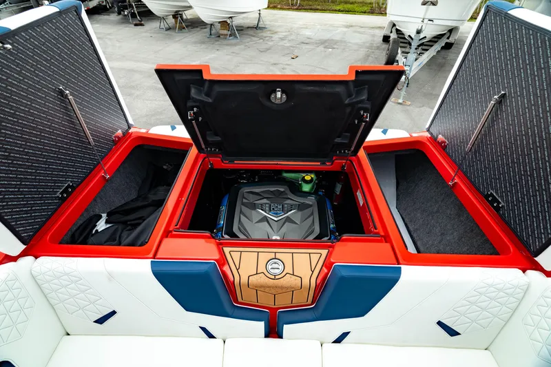 Slide: The Image of 2025 Nautique Super Air Nautique GS20 engine compartment with vibrant red and blue accents. - 23