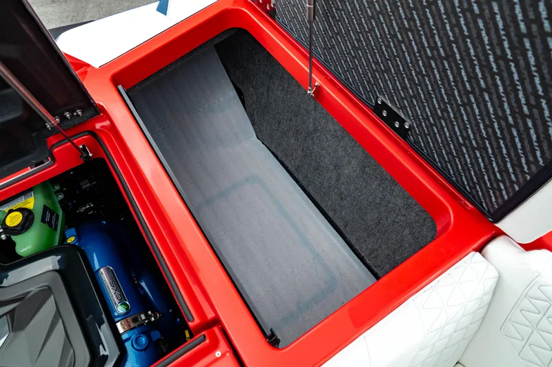 Slide: The Image of 2025 Nautique Super Air Nautique GS20 storage compartment with engine view. - 25