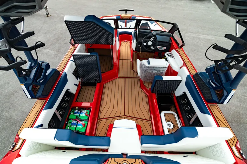 Slide: The Image of 2025 Nautique Super Air Nautique GS20 interior with red and blue accents, luxury seating, and advanced controls. - 27