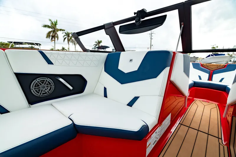 Slide: The Image of 2025 Nautique Super Air Nautique GS20 interior with red, white, and blue seating. - 29