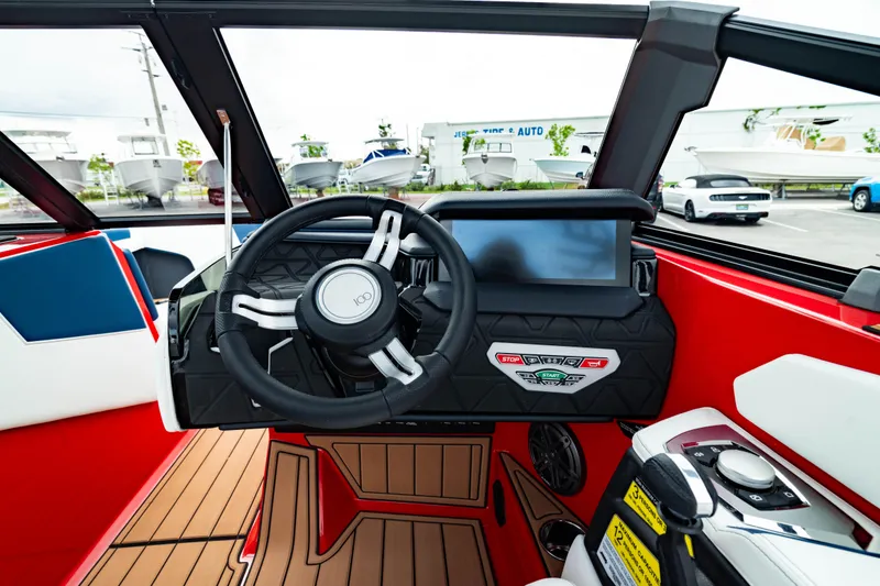Slide: The Image of 2025 Nautique Super Air Nautique GS20 dashboard with modern steering and touchscreen display. - 32