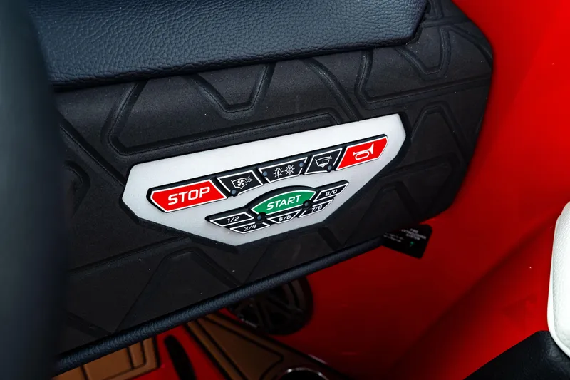 Slide: The Image of Control panel of 2025 Nautique Super Air Nautique GS20 with start and stop buttons. - 33