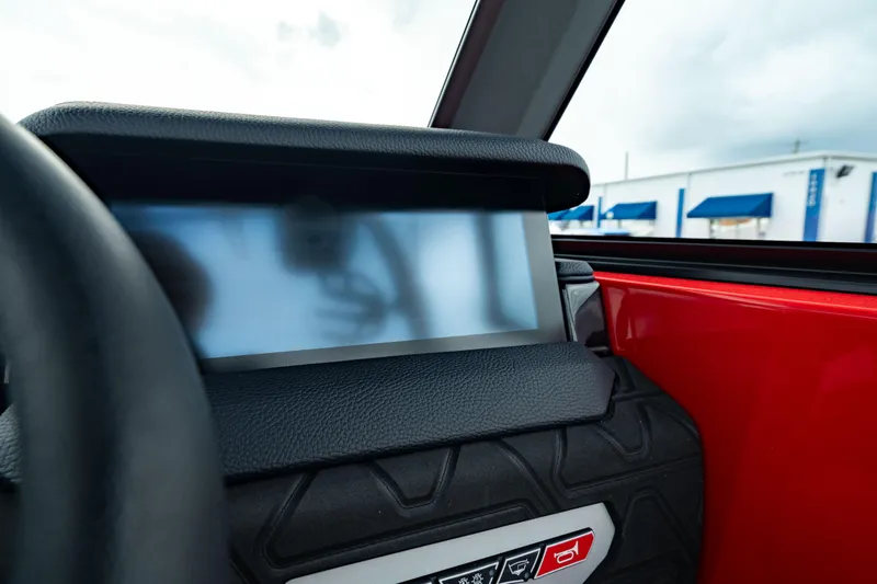 Slide: The Image of 2025 Nautique Super Air Nautique GS20 dashboard with touchscreen display and red interior. - 34