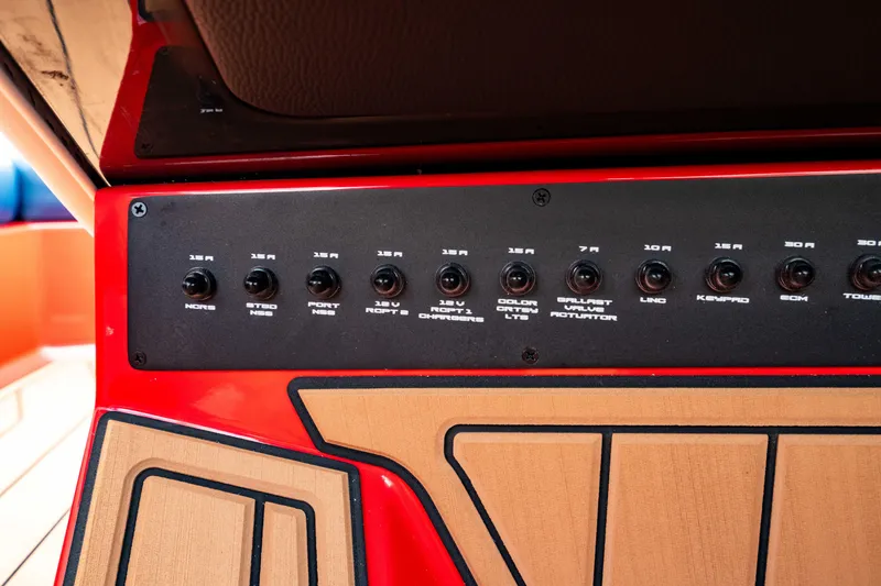 Slide: The Image of Control panel of 2025 Nautique Super Air Nautique GS20 boat, featuring various switches. - 37
