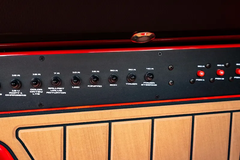 Slide: The Image of Control panel of 2025 Nautique Super Air Nautique GS20 boat, featuring various switches and dials. - 38