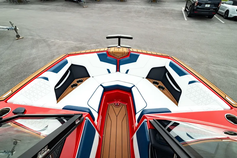 Slide: The Image of 2025 Nautique Super Air Nautique GS20 boat interior with red, white, and blue seating. - 42