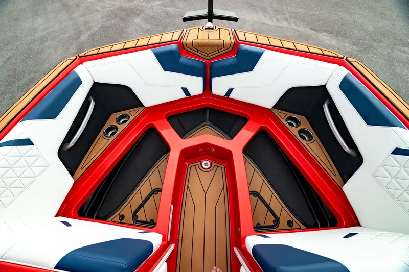 Slide: The Image of 2025 Nautique Super Air Nautique GS20 boat interior with red, white, and blue seating. - 45