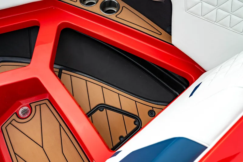 Slide: The Image of 2025 Nautique Super Air Nautique GS20 interior with red accents and cup holders. - 46