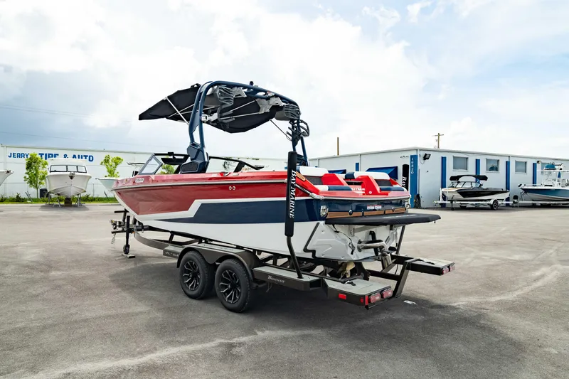 Slide: The Image of 2025 Nautique Super Air Nautique GS20 boat on trailer in parking lot. - 5