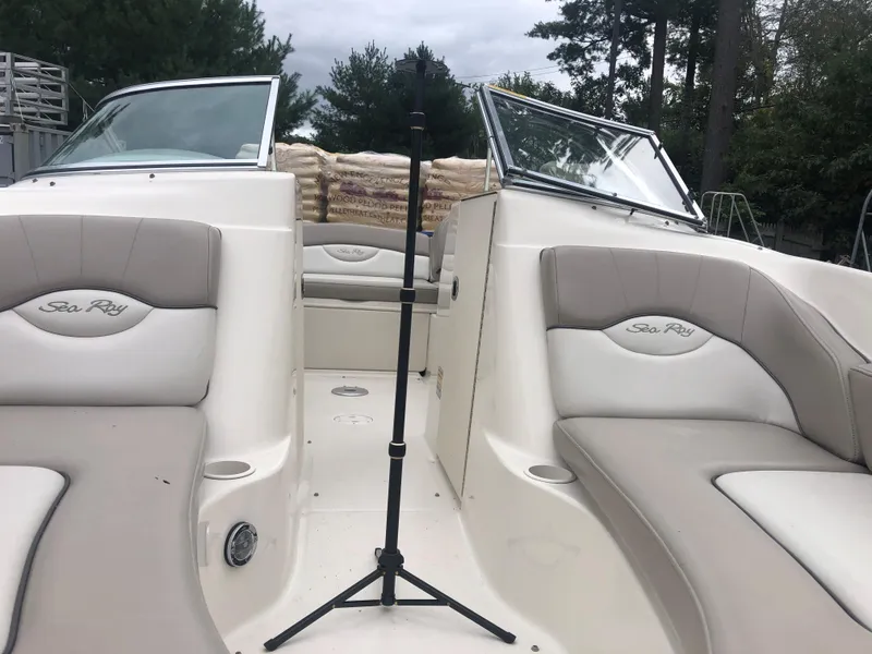 Slide: The Image of 2003 Sea Ray 200 Sundeck boat interior with beige seating and open deck. - 6