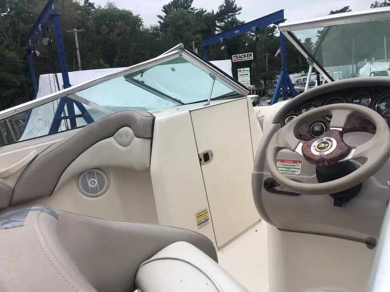 Slide: The Image of 2003 Sea Ray 200 Sundeck boat interior with steering wheel and seating. - 7