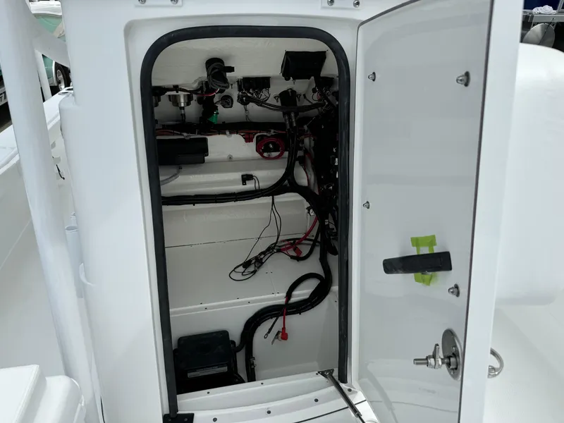 Slide: The Image of 2025 BlackJack 256 Coastal boat interior wiring and storage compartment. - 17