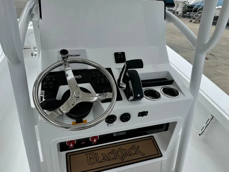 Slide: The Image of 2025 BlackJack 256 Coastal boat console with steering wheel and controls. - 20