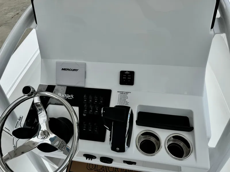 Slide: The Image of 2025 BlackJack 256 Coastal boat dashboard with steering wheel and controls. - 21