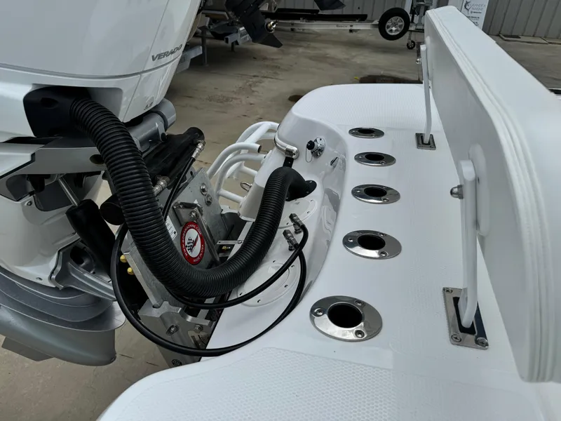 Slide: The Image of 2025 BlackJack 256 Coastal boat engine and deck with rod holders. - 26