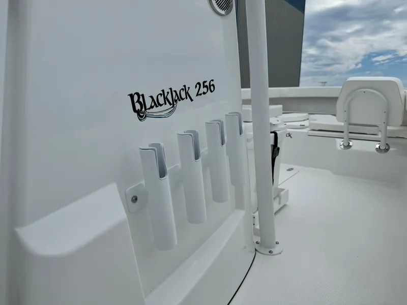 Slide: The Image of 2025 BlackJack 256 Coastal boat interior with rod holders and seating. - 30