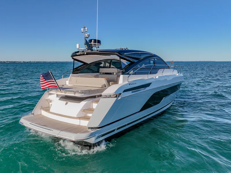 Slide: The Image of 2025 Fairline Targa 45 Open yacht cruising on clear blue water. - 2