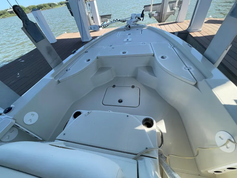 Slide: The Image of 2014 Triton 240 LTS Pro boat interior with spacious deck and storage compartments. - 11